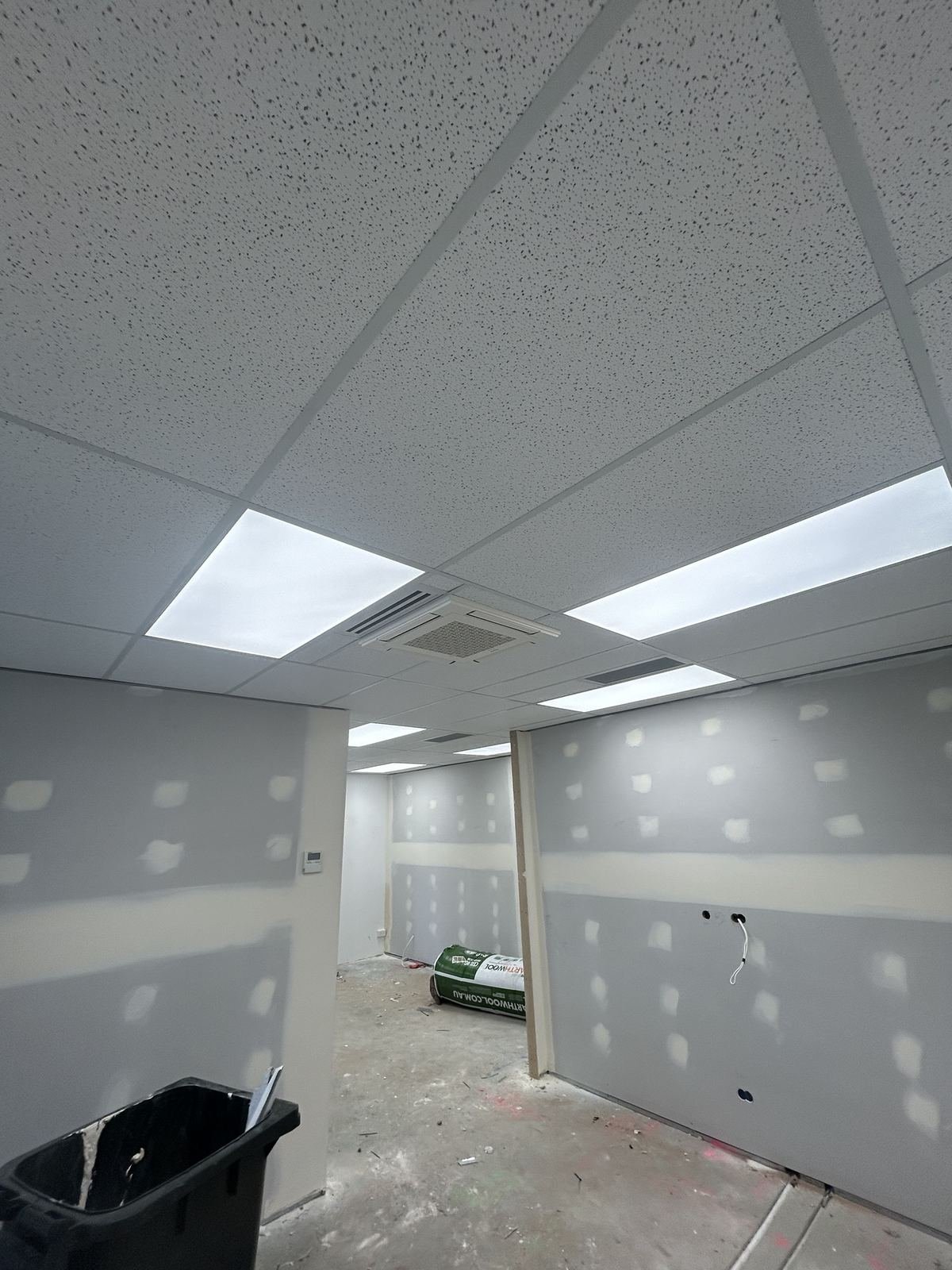 Suspended tile ceiling and plasterboard walls set ready for paint in a commercial office fitout